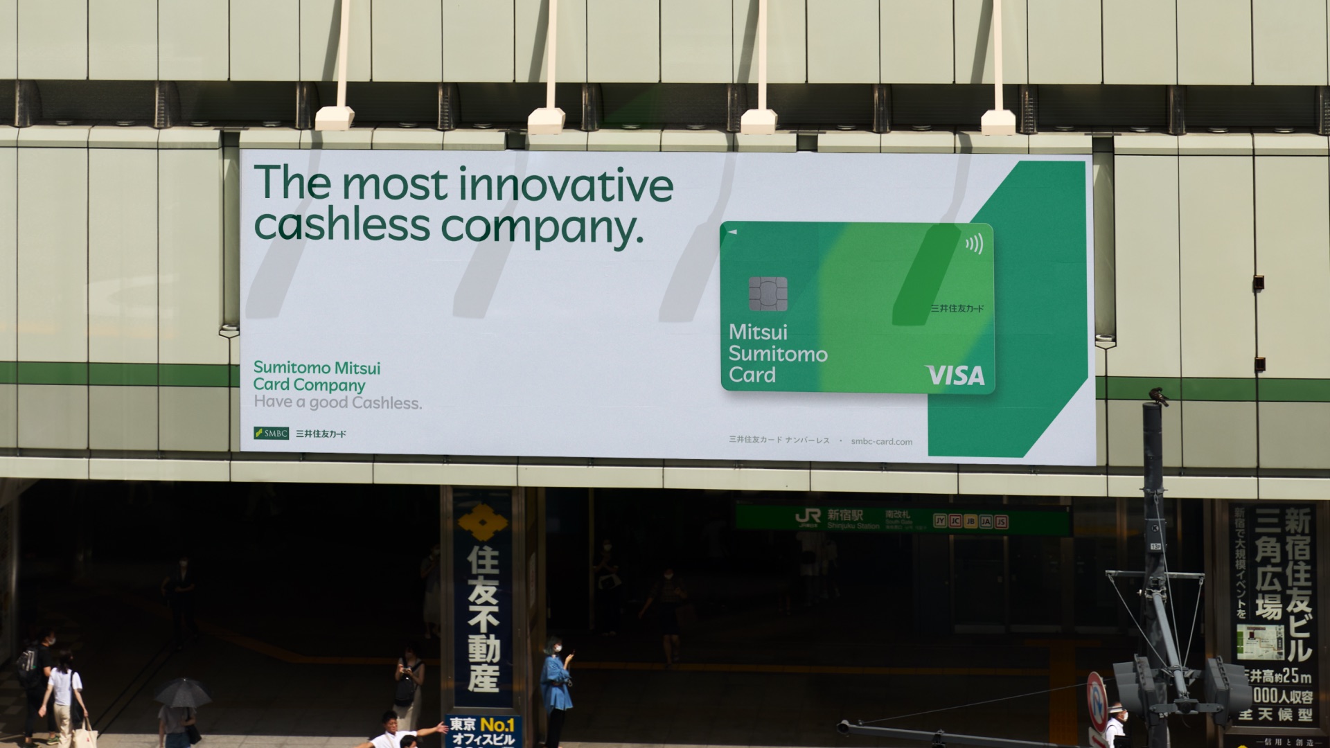 “The most innovative cashless company.” billboard above a Tokyo street — SMCC Headline typeface