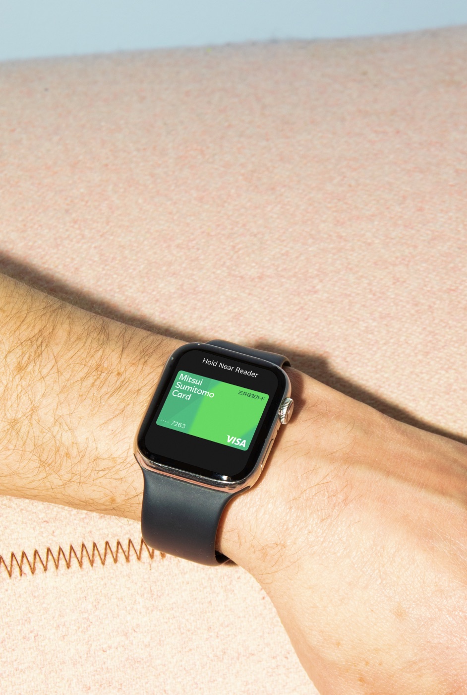 Smartwatch on a wrist showing a Mitsui Sumitomo Card payment screen — SMCC typeface case study